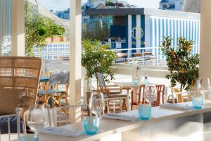 a patio with tables and chairs on a balcony at Molitor Hotel & Spa Paris - MGallery Collection in Paris +290 photos