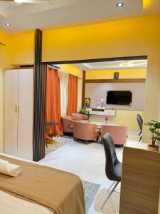 a bedroom with a bed and a living room at Residence MBK Studio 1 in Ziguinchor