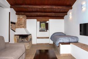 a living room with a bed and a fireplace at Tenuta Luogo Marchese in Pollina