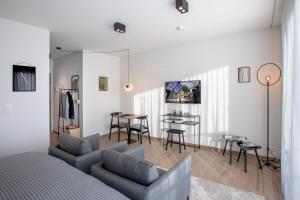 a living room with a bed and a table at Q-Stay in Antwerp