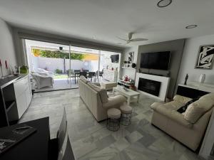 a living room with two couches and a fireplace at PuertoHouse in El Puerto de Santa María