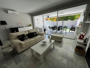 a living room with a couch and a table at PuertoHouse in El Puerto de Santa María
