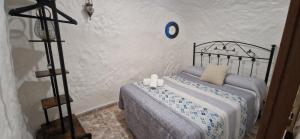a bedroom with a bed with two candles on it at Casa Cueva Calatrava in Tabernas