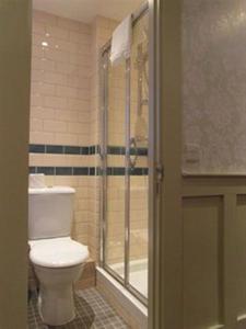 a bathroom with a toilet and a shower stall at Brooks Hotel in Edinburgh