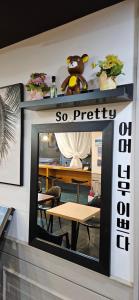 a mirror on a wall with a table in a room at EKonomy Hotel Incheon Bupyeong Branch in Incheon
