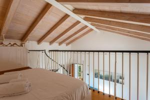 a bedroom with a bed and wooden ceilings at Yourbanflat Ring River in Padova