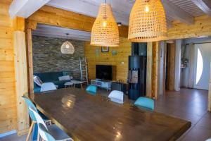 a dining room with a large wooden table and chairs at Gite de Mortagne, Villa avec Piscine in Gigny-sur-Saône