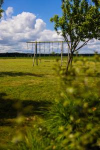 a soccer field with a goal in the grass at Gite de Mortagne, Villa avec Piscine in Gigny-sur-Saône