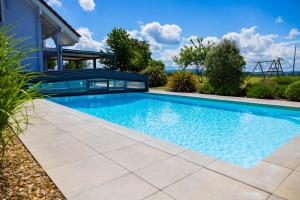 a swimming pool in a yard with a house at Gite de Mortagne, Villa avec Piscine in Gigny-sur-Saône +29 photos