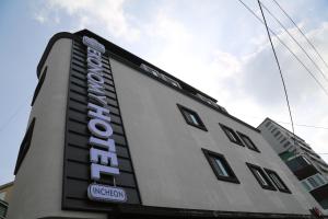 a building with a sign on the side of it at EKonomy Hotel Incheon Bupyeong Branch in Incheon +142 photos