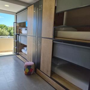 a room with bunk beds and a soccer ball on the floor at Hostel Petra Marina in Dubrovnik