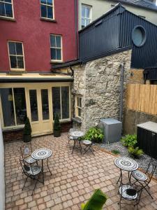 a patio with tables and chairs in front of a building at NO 60 Sligo in Sligo