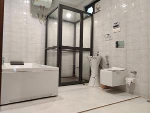 a bathroom with a shower and a sink and a toilet at Hotel Heaven and Hills in Kasauli