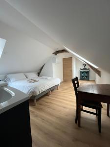 a bedroom with a bed and a desk and a table at Domaine le bas bois in Neuville-sur-Sarthe +30 photos