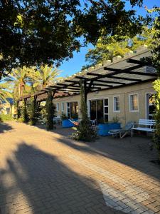 a patio with a bench and a building at Capbon Guesthouse in Windhoek +51 photos