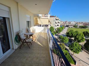a balcony with a table and chairs on a building at Ippokratis 1 in Larisa