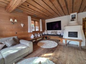 a living room with a couch and a fireplace at Eberlehof in Riezlern