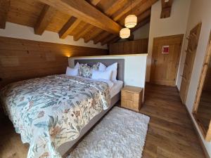 a bedroom with a bed in a room with wooden ceilings at Eberlehof in Riezlern
