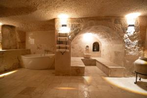 a large bathroom with a tub and a sink at Helike Cave Suites in Uçhisar +102 photos