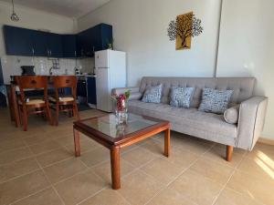 a living room with a couch and a table at Ippokratis 1 in Larisa