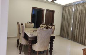 a dining room with a wooden table and chairs at Hotel Heaven and Hills in Kasauli +73 photos