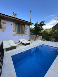 a swimming pool in front of a house at Riverside Jahliye, Chouf in Al Jāhilīyah
