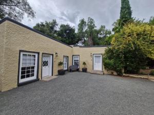 a house with two garage doors and a gravel driveway at Coniston Villa in Colesberg +9 photos