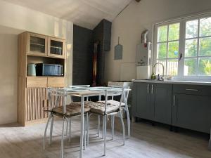 a kitchen with a table and chairs in a room at Chalet Eden Insolite in Pionnat