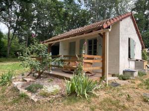 a small white building with a porch and a yard at Chalet Eden Insolite in Pionnat +20 photos