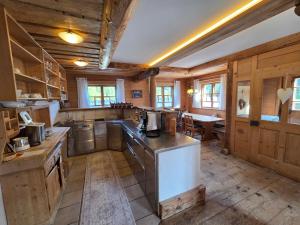 a large kitchen with wooden walls and wooden counters at Eberlehof in Riezlern