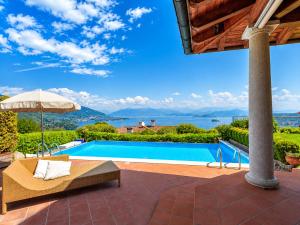 a villa with a pool and a view of the water at Villa Marta in Meina