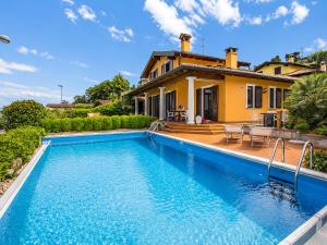 a house with a swimming pool in front of a house at Villa Marta in Meina +26 photos