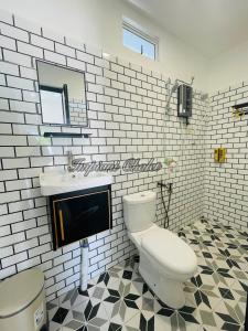 a bathroom with a toilet and a sink at Impiani Chalet with Private Pool in Kuala Terengganu