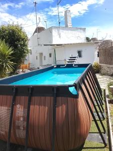 a large swimming pool in front of a house at Trullo martina in Martina Franca