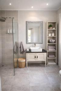 a bathroom with a sink and a mirror at 19 on Amber in Ugie