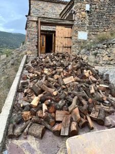 a pile of logs in front of a building at Casa Purujosa in Purujosa
