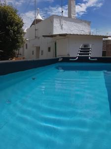 a large blue swimming pool in front of a building at Trullo martina in Martina Franca