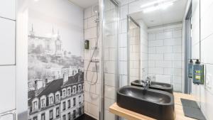 a bathroom with a black sink and a window at Campanile PRIME - Lyon Meyzieu Eurexpo Arena Stadium in Meyzieu +30 photos