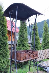 a black umbrella on a table in a yard at Садиба "Едем" in Mykulychyn