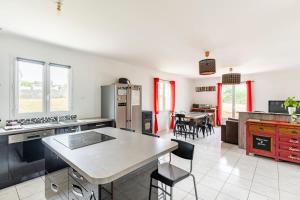 a kitchen with a table and some chairs in it at Petite maison chaleureuse avec une vue imprenable in Esson