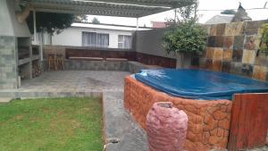 a large hot tub in a yard with a house at Nightingale Guesthouse Randfontein in Randfontein