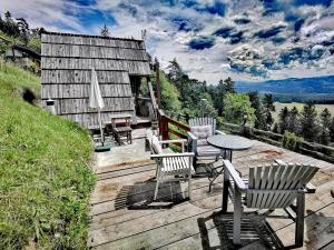 a deck with chairs and a table and a house at Glamping MM in Muta +52 photos
