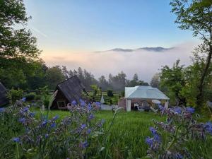 a view of a field with a tent in the fog at Glamping MM in Muta