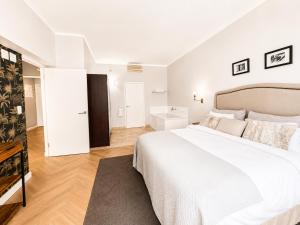 a white bedroom with a large bed and a bathroom at Cape Town Panorama Luxe Suite in Cape Town +25 photos