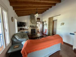 a living room with a couch and a fireplace at Casa Puerta Azul By Solymar Properties in Almáchar