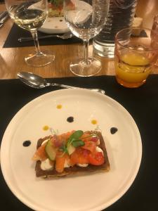 a white plate with a piece of food on a table at La Varenne in Changy