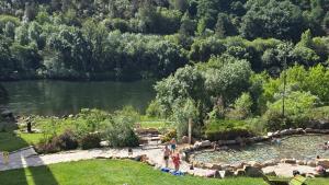 a group of people standing in a park near a lake at Loft Casco Viejo 3 in Ourense