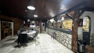 a dining room with a table in a restaurant at l'Orée des Moraines in Monnet-la-Ville