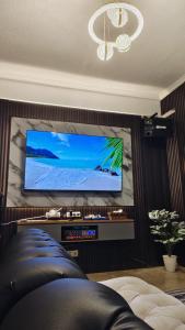 a living room with a flat screen tv on a wall at Ocean Breeze Carita in Carita