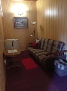 a living room with a couch and a table at Zakarpatska Kolyba in Odesa